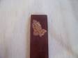 This is a leather book mark that is stamped with Praying