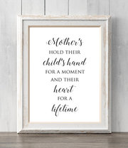 Mother's hold their child's hand for for a moment. Mom.